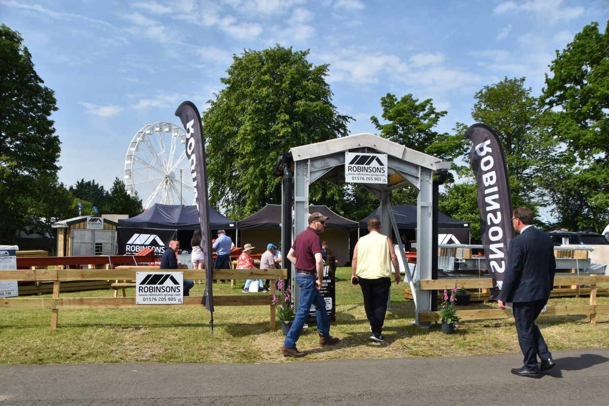 The entrance of the Robinsons stand at the Royal Highland Show. Featuring a steel-framed archway flanked either side with black Robinsons teardrop flags