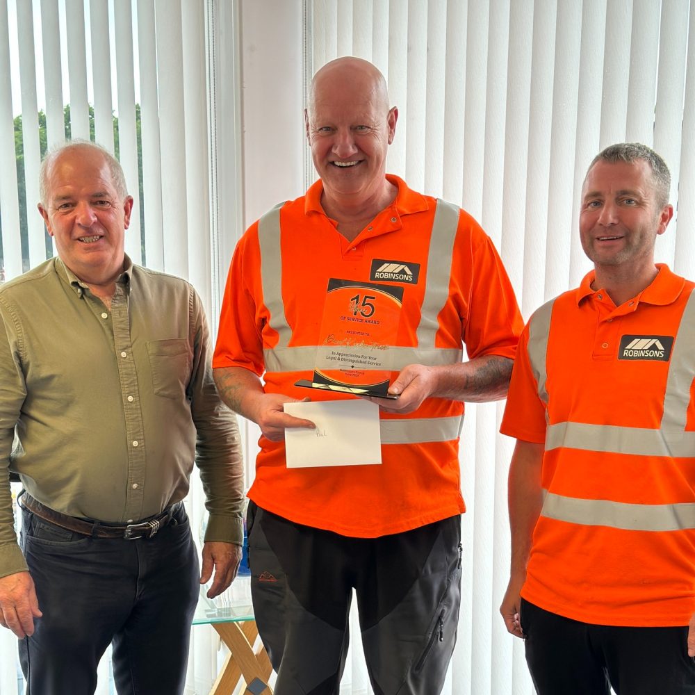 Jim, Paul and Stevie - with Paul standing in the middle showcasing his 15 years trophy and certificate.