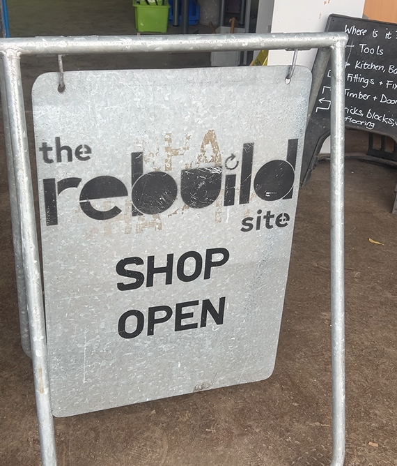 The Rebuild Site CIC shop open sign - welcoming visitors to their Carlisle hub aimed at reducing construction waste